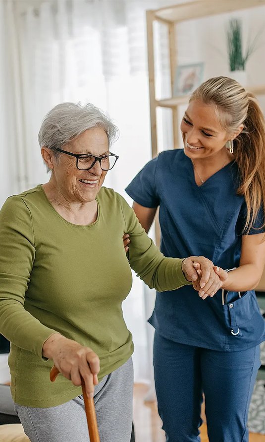 Dedicated caregiver assisting a senior with daily routines through in-home care for elderly near me services.
